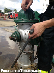 Image demonstrating how to slide hydrant wrench along the chain.