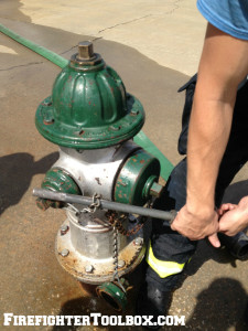 Image demonstrating how to slide a wrapped chain down the shaft of the hydrant wrench.